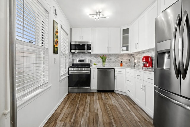 100-15 Ascan Ave, New York City, NY 11375 - kitchen featuring stainless steel appliances, light countertops, dark wood-style floors, and backsplash