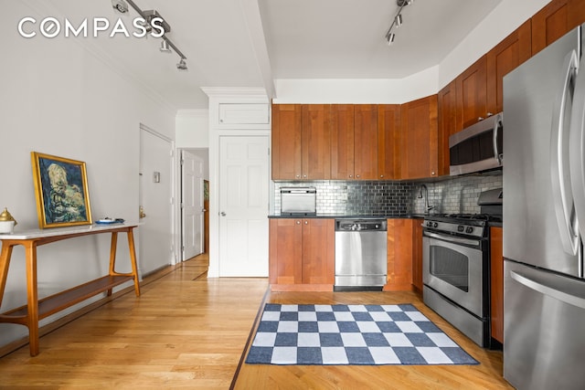 466 15th St Unit 8, New York City, NY 11215 - kitchen featuring appliances with stainless steel finishes, rail lighting, dark countertops, tasteful backsplash, and light wood finished floors