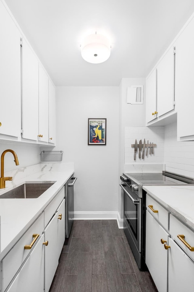 708 Washington St Unit 5B, New York City, NY 10014 - kitchen with stainless steel appliances, dark wood finished floors, backsplash, and white cabinets