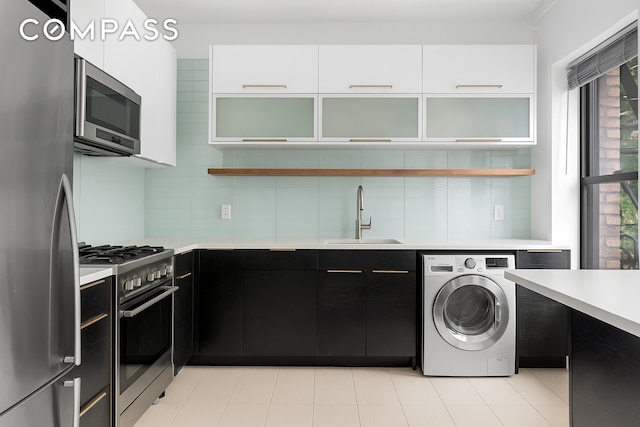 394 Lincoln Pl Unit C2, New York City, NY 11238 - kitchen featuring appliances with stainless steel finishes, washer / dryer, dark cabinets, open shelves, and light countertops