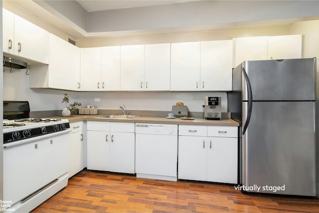225 E 86th St Unit 801, New York City, NY 10028 - kitchen with white appliances, wood finished floors, and white cabinetry