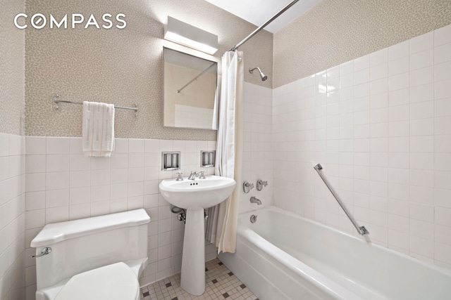 650 Park Ave Unit 18C, New York City, NY 10065 - full bathroom with shower / bath combination with curtain, wainscoting, and tile walls