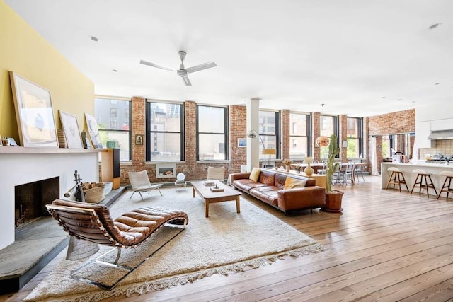 525 W 22nd St Unit 3Af, New York City, NY 10011 - living room featuring light wood finished floors, a fireplace with raised hearth, and a ceiling fan