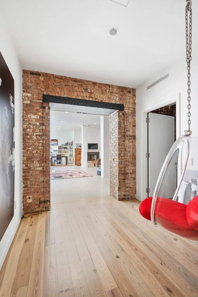 525 W 22nd St Unit 3Af, New York City, NY 10011 - hall with hardwood / wood-style floors and brick wall