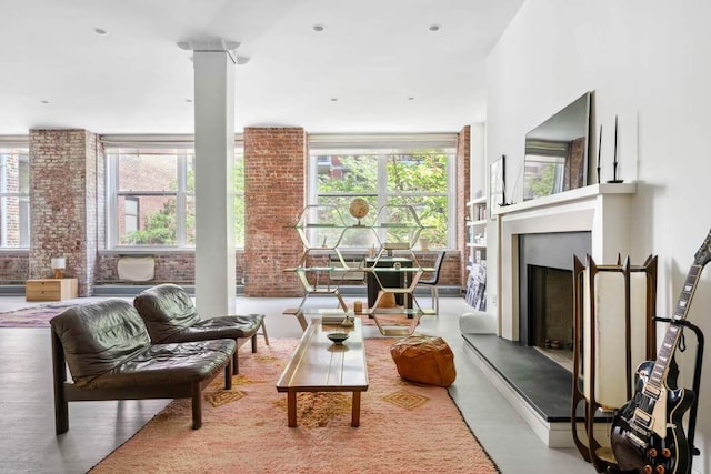 525 W 22nd St Unit 3Af, New York City, NY 10011 - living area with plenty of natural light, a fireplace with raised hearth, and brick wall