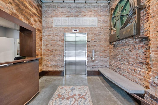 525 W 22nd St Unit 3Af, New York City, NY 10011 - kitchen with elevator, finished concrete floors, and brick wall