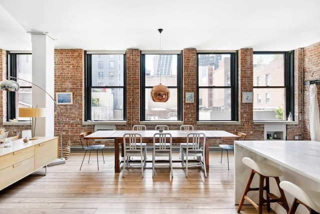 525 W 22nd St Unit 3Af, New York City, NY 10011 - dining room with brick wall and light wood-style floors