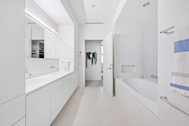 525 W 22nd St Unit 3Af, New York City, NY 10011 - bathroom with a garden tub, double vanity, and tile patterned flooring