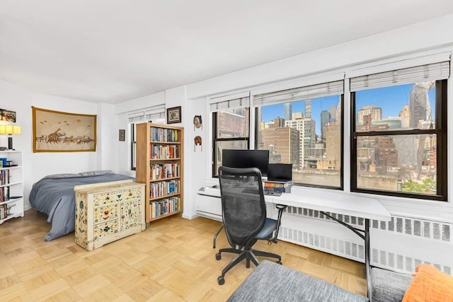 245 E 24th St Unit 14A, New York City, NY 10010 - bedroom featuring radiator heating unit and a desk