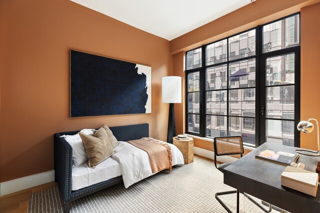 517 W 29th St Unit 8B, New York City, NY 10001 - bedroom with baseboards and wood finished floors