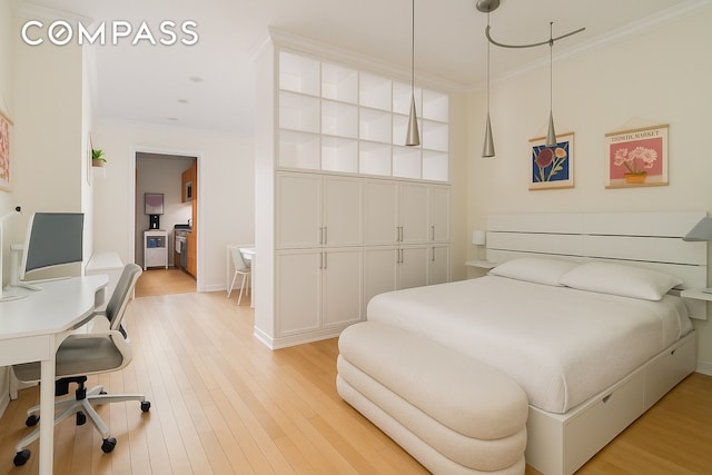 450 E 83rd St Unit 5F, New York City, NY 10028 - bedroom with crown molding, light wood-style floors, and a desk