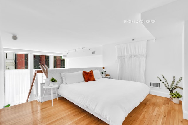 121 W 19th St Unit 3D, New York City, NY 10011 - bedroom with light wood-style flooring and rail lighting