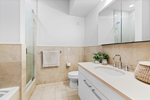 121 W 19th St Unit 3D, New York City, NY 10011 - bathroom featuring vanity, tile walls, a stall shower, tile patterned floors, and a bathtub