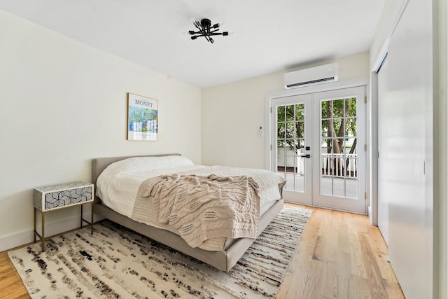 449 Pulaski St, New York City, NY 11221 - bedroom featuring a wall mounted air conditioner, french doors, light wood finished floors, and access to exterior
