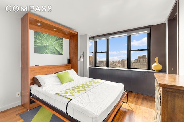 201 E 17th St Unit 31E, New York City, NY 10003 - bedroom featuring light wood-style flooring and baseboards