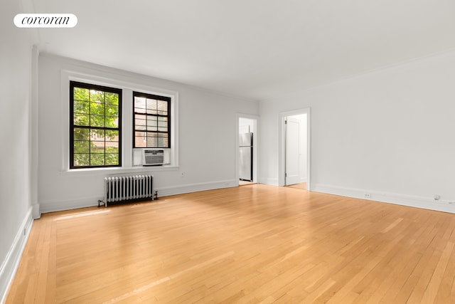 6 Burns St Unit 220, New York City, NY 11375 - spare room featuring radiator heating unit, light wood finished floors, cooling unit, and ornamental molding