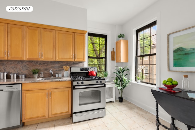6 Burns St Unit 220, New York City, NY 11375 - kitchen with stainless steel appliances, plenty of natural light, light tile patterned floors, and backsplash