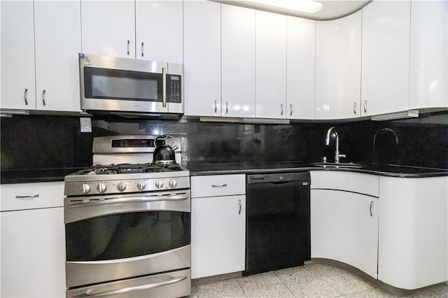 7007 Narrows Ave, New York City, NY 11209 - kitchen featuring stainless steel appliances, decorative backsplash, white cabinetry, and dark countertops