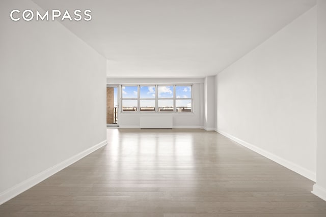 135 Ocean Pkwy Unit 9M, New York City, NY 11218 - spare room with wood finished floors and radiator heating unit