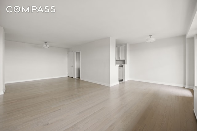 135 Ocean Pkwy Unit 9M, New York City, NY 11218 - unfurnished living room with light wood finished floors and baseboards