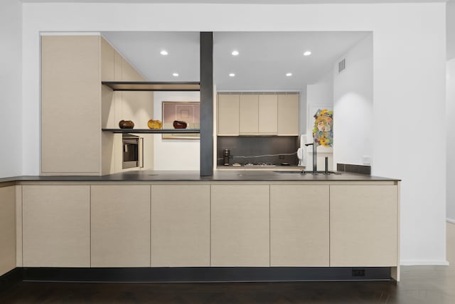 15 W 53rd St Unit 20E, New York City, NY 10019 - kitchen with cream cabinetry, modern cabinets, recessed lighting, and dark countertops