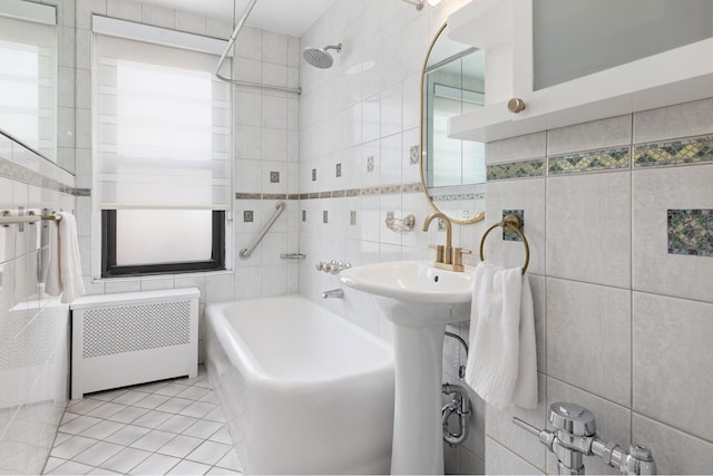 235 W End Ave Unit 16A, New York City, NY 10023 - full bath featuring radiator heating unit, tile walls, tile patterned floors, and  shower combination