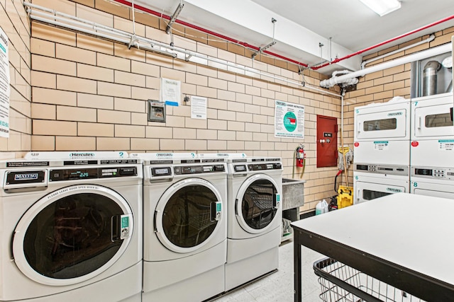 320 E 35th St Unit 2H, New York City, NY 10016 - shared laundry room with estacked washer and dryer, separate washer and dryer, and tile walls