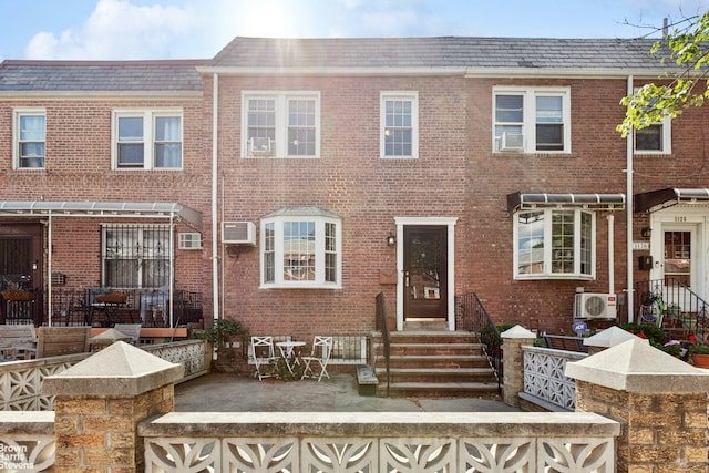 31-28 56th St, New York City, NY 11377 - townhome / multi-family property with brick siding and an AC wall unit