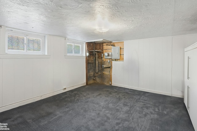 31-28 56th St, New York City, NY 11377 - basement with dark carpet and a textured ceiling