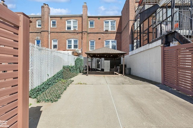 31-28 56th St, New York City, NY 11377 - back of house featuring a gazebo, a patio, and brick siding