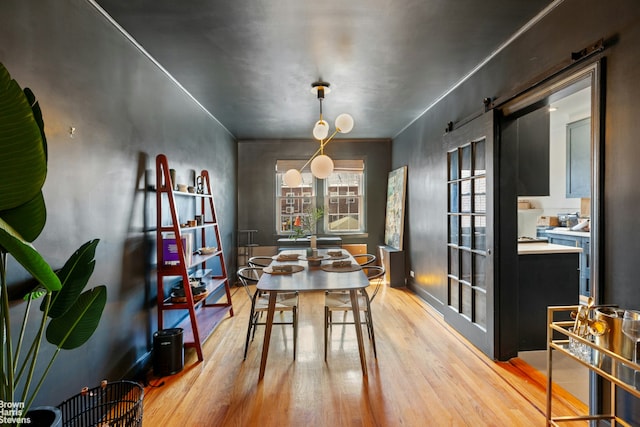 31-28 56th St, New York City, NY 11377 - dining space with light wood finished floors and a barn door
