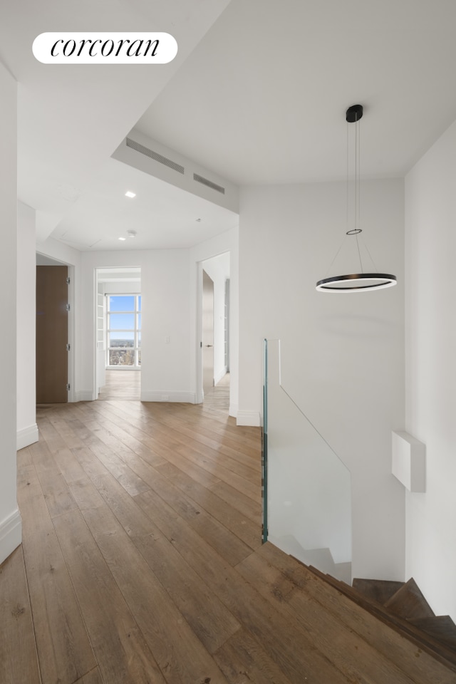 146 W 57th St Pha, Pha, New York City, NY 10019 - hallway featuring an upstairs landing, light wood-style flooring, and recessed lighting