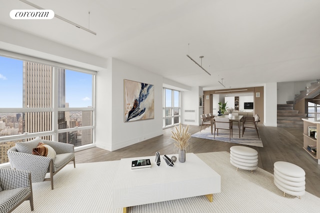 146 W 57th St Pha, Pha, New York City, NY 10019 - living room featuring wood finished floors, stairs, and plenty of natural light