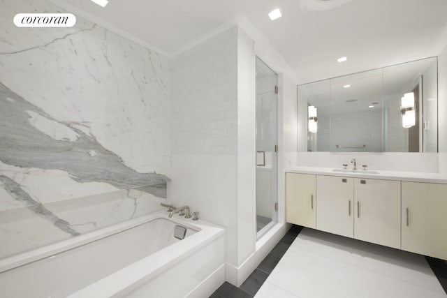 146 W 57th St Pha, Pha, New York City, NY 10019 - bathroom with vanity, a garden tub, a stall shower, and tile patterned floors