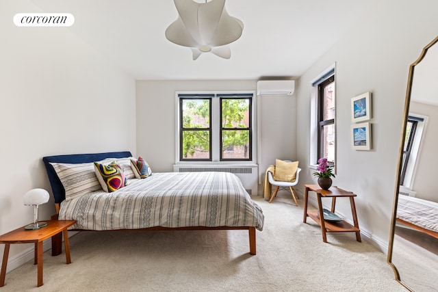125 Ocean Ave Unit 6F, New York City, NY 11225 - bedroom with radiator heating unit, a wall mounted AC, light carpet, and a ceiling fan
