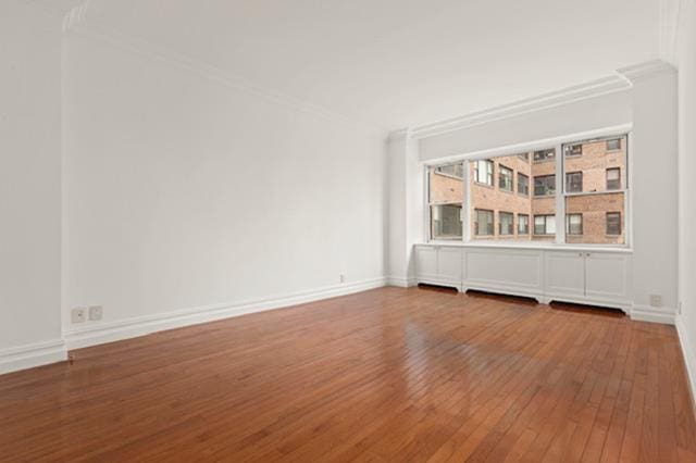 340 E 64th St Unit 9-B, New York City, NY 10065 - unfurnished room with ornamental molding and wood-type flooring