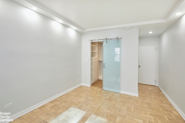 63 E 9th St Unit 9G, New York City, NY 10003 - unfurnished bedroom with a barn door, recessed lighting, and a spacious closet