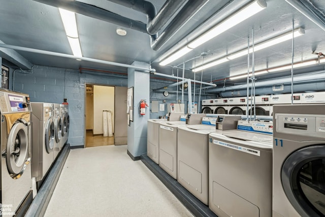 330 3rd Ave Unit 15E, New York City, NY 10010 - communal laundry room with independent washer and dryer and concrete block wall