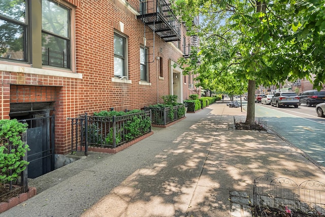 30-83 Crescent St Unit 3A, New York City, NY 11102 - view of property exterior featuring brick siding and a garden