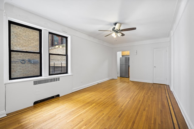 30-83 Crescent St Unit 3A, New York City, NY 11102 - unfurnished bedroom with freestanding refrigerator, light wood-style flooring, radiator heating unit, a closet, and ceiling fan