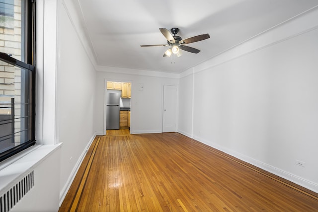 30-83 Crescent St Unit 3A, New York City, NY 11102 - unfurnished bedroom with freestanding refrigerator, light wood-style flooring, crown molding, and ceiling fan