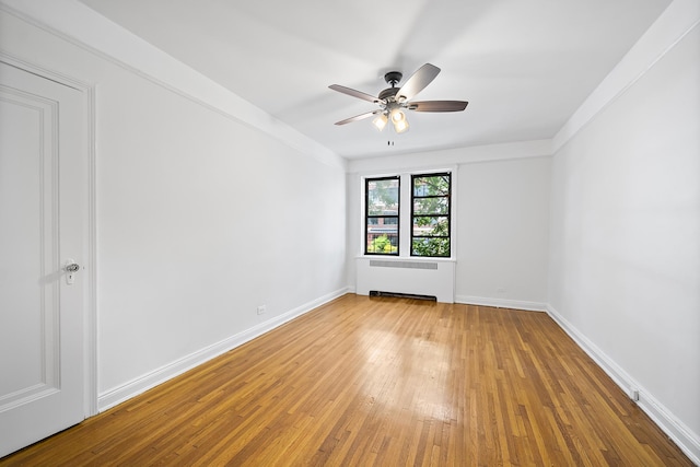 30-83 Crescent St Unit 3A, New York City, NY 11102 - unfurnished room featuring radiator heating unit, ceiling fan, and light wood-type flooring