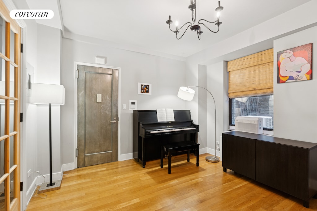 308 W 30th St Unit 1A, New York City, NY 10001 - sitting room with a chandelier, light wood-type flooring, and cooling unit