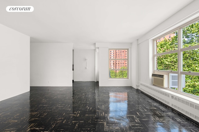 80 La Salle St Unit 6D, New York City, NY 10027 - empty room with plenty of natural light, radiator, and a wall mounted AC