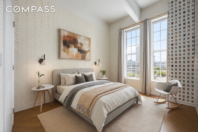 184 Kent Ave Unit B503, New York City, NY 11249 - bedroom with wallpapered walls, multiple windows, and beamed ceiling