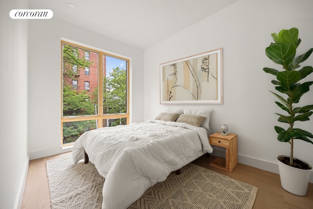 184 Hawthorne St Unit 4B, New York City, NY 11225 - bedroom featuring baseboards and wood finished floors