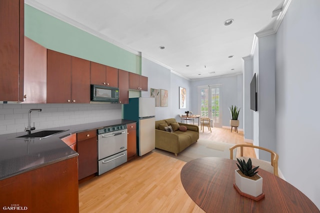 248 E 33rd Street Townhouse, New York City, NY 10016 - kitchen featuring black microwave, freestanding refrigerator, dishwasher, crown molding, and light wood-style floors