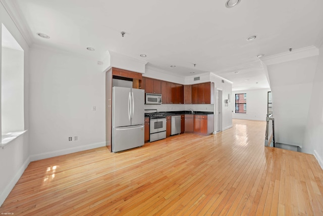 248 E 33rd Street Townhouse, New York City, NY 10016 - kitchen with appliances with stainless steel finishes, dark countertops, open floor plan, light wood-style floors, and ornamental molding