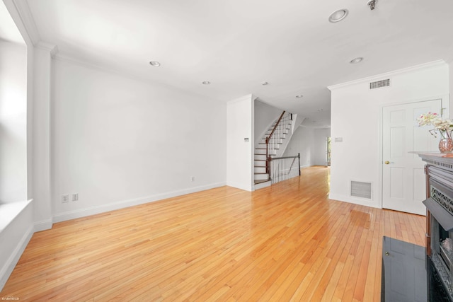 248 E 33rd Street Townhouse, New York City, NY 10016 - unfurnished living room featuring ornamental molding, recessed lighting, light wood-style flooring, and stairway