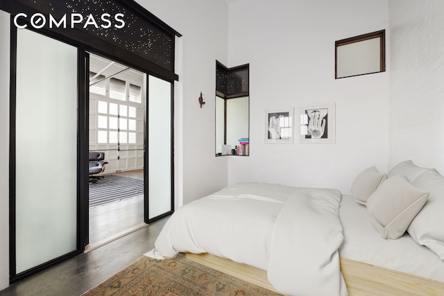 125 Watts St Unit 1, New York City, NY 10013 - bedroom featuring a towering ceiling, access to outside, and finished concrete floors